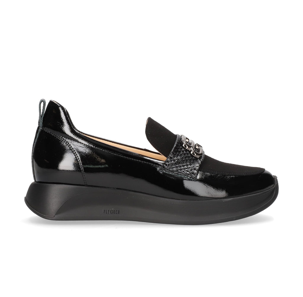 Black patent leather loafer with a platform sole on a white background