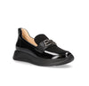 Black patent leather loafer on a white background